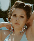 Silver mirror acrylic Medium Salmon Ghost earrings from Copper Canoe Woman worn by a model.