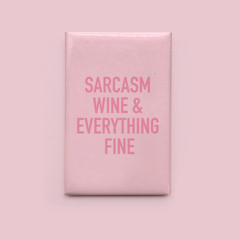 Pink square sign with text 'SARCASM WINE & EVERYTHING FINE' on a pink background