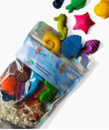 Set of colorful sea-themed bath toys with packaging on a white background