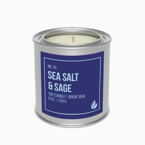 Candle in a tin labeled 'Sea Salt & Sage' on a white background