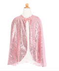 A pink sequined cape with a matching bow at the collar, displayed on a white mannequin torso against a plain white background.