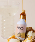 Shroom Soda bottle with ice cream and caramel sauce on a light background