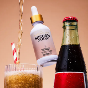 Siroom Soda bottle being poured into a glass with a straw, against a brown background