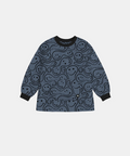 A long-sleeve children's smock in slate blue with an all-over black smiley face pattern, featuring black ribbed collar, cuffs, and hem, displayed flat against a light gray background.