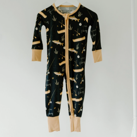 Black onesie with beige accents and animal print on a white background