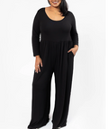 Woman wearing a black jumpsuit on a white background