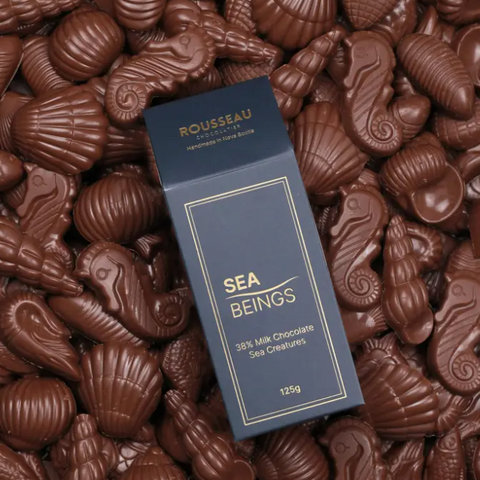Rousseau Sea Beings chocolate packaging surrounded by chocolate sea creature shapes