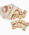 Wooden alphabet blocks with colorful letters and a bag labeled 'Wooden Blocks' on a white background.