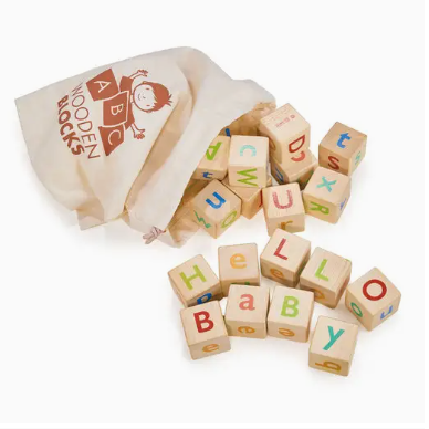 Wooden alphabet blocks with colorful letters and a bag labeled 'Wooden Blocks' on a white background.