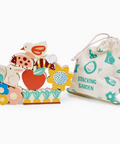 Colorful wooden stacking garden toys with a drawstring bag labeled 'Stacking Garden' on a white background.