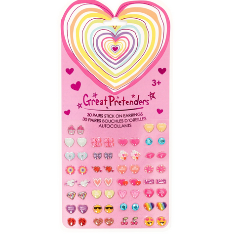 A pink card of Great Pretenders stick-on earrings for children, featuring a large rainbow heart design at the top and rows of colorful heart-shaped and character earrings below.