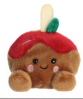 Plush toy resembling a brown bear with a red apple on its head against a white background