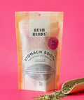 Tea package labeled 'Bush Berry Stomach Soothe' on a pink background