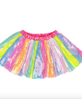 A children's sequin tutu skirt with a bright pink elastic waistband, featuring vertical panels of neon pink, yellow, green, blue, and orange sequins on a white background.