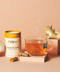 Tea with 'ease' turmeric tonic packaging on a peach background