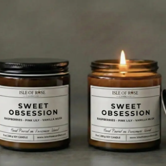 Two candles labeled 'Sweet Obsession' by Isle of Rose on a neutral background