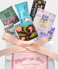 Mystery bag of assorted sweet treats with colorful packaging on a light gray background