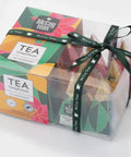 Box of McCoy Teas tea bags with colorful packaging and a black ribbon on a white background