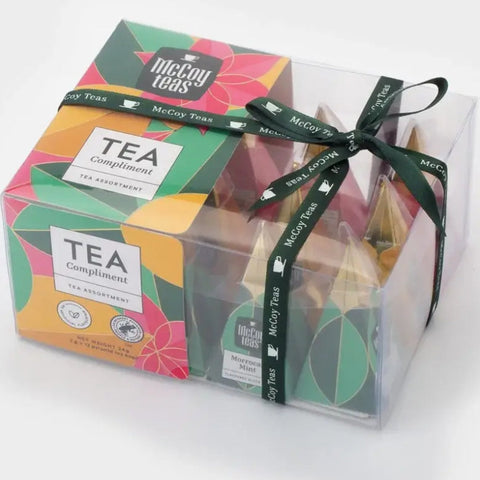 Box of McCoy Teas tea bags with colorful packaging and a black ribbon on a white background
