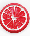 Red and white circular object resembling a grapefruit slice on a white background