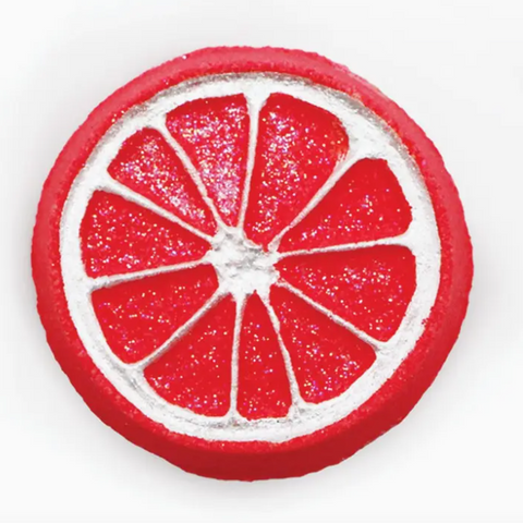 Red and white circular object resembling a grapefruit slice on a white background