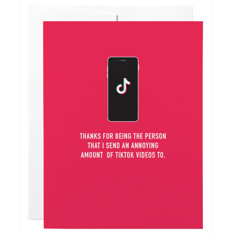 Red card with a phone displaying TikTok logo and humorous text on a white background
