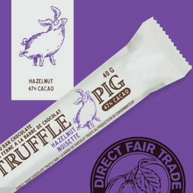 Chocolate bar packaging with 'Pig' branding and Direct Fair Trade logo on a purple background