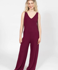 Woman wearing a burgundy jumpsuit on a white background