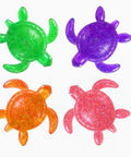 Four Turtley Awesome turtle-shaped squishy toys in different colours green purple orange pink