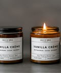 Two 'Vanilla Crème' candles from Isle of Rose Candle Co. on a gray background.
