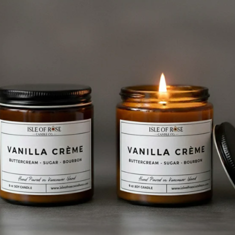 Two 'Vanilla Crème' candles from Isle of Rose Candle Co. on a gray background.