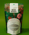 Tea package with 'BUSH BERRY' branding on a green background