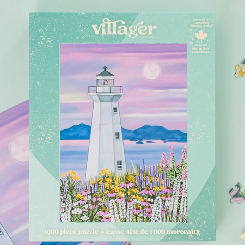 A 1000-piece jigsaw puzzle box by Villager Puzzles, featuring a colorful illustration of a white lighthouse surrounded by pink, purple, and yellow wildflowers under a pastel sky with a moon and distant blue hills.