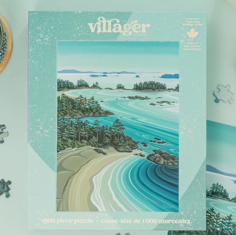 Villager Design 1000-piece coastal landscape jigsaw puzzle box, featuring a turquoise and teal beach, forest, and rocky shoreline illustration on a mint background.