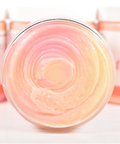 Jar of pink cream with a blurred background