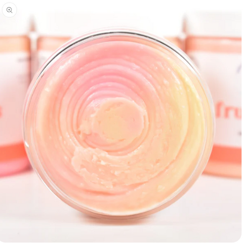 Jar of pink cream with a blurred background