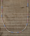 Necklace with colorful beads on a wooden surface