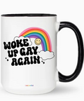 Mug with rainbow, smiley face, and text 'Woke Up Gay Again' on a white background