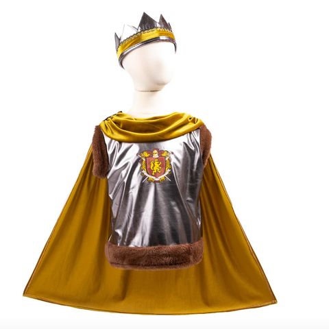 A children's royal costume set displayed on a white mannequin against a white background, featuring a metallic silver cape with brown faux-fur trim, a golden-yellow velvet hood, a matching crown, and a printed royal crest on the back of the cape.