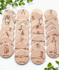 Set of wooden discs with yoga poses illustrations on a white background
