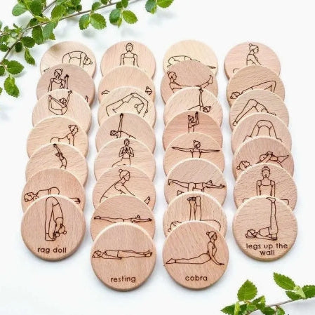 Set of wooden discs with yoga poses illustrations on a white background