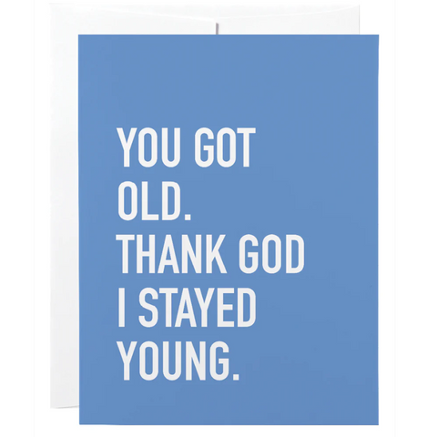 Blue card with white text 'YOU GOT OLD. THANK GOD I STAYED YOUNG.' on a white background