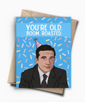 Greeting card with a cartoon character wearing a party hat and text 'You're old. Boom. Roasted.' on a blue background.
