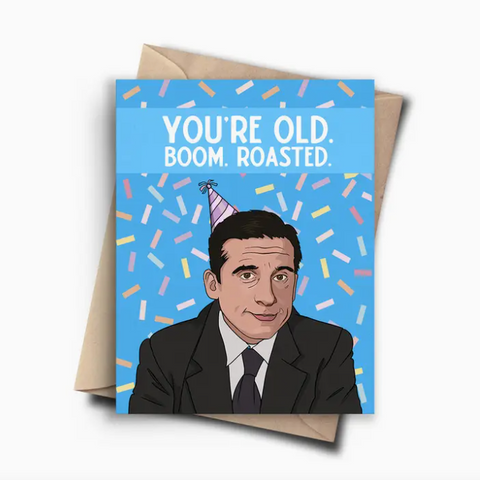 Greeting card with a cartoon character wearing a party hat and text 'You're old. Boom. Roasted.' on a blue background.